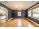 Elegant dining room featuring stylish wallpaper and ample sunlight, adjacent to the kitchen at 2400 Commonwealth Ave, Charlotte, NC 28205