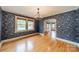 Stylish dining room with hardwood floors, ornate wallpaper, and an arched entryway at 2400 Commonwealth Ave, Charlotte, NC 28205