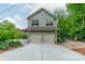 Two-car garage with neutral siding and a concrete driveway, complementing the home's architecture at 2400 Commonwealth Ave, Charlotte, NC 28205