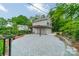 Detached two-car garage with ample parking and a covered patio area, surrounded by lush landscaping at 2400 Commonwealth Ave, Charlotte, NC 28205