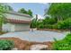 Spacious stone patio and pergola attached to the side of a detached two car garage at 2400 Commonwealth Ave, Charlotte, NC 28205