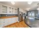 Modern kitchen featuring stainless steel appliances, white cabinets, and hardwood floors at 2400 Commonwealth Ave, Charlotte, NC 28205