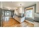 Bright kitchen with white cabinetry, stainless steel appliances, and hardwood flooring at 2400 Commonwealth Ave, Charlotte, NC 28205