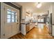 Updated kitchen with white cabinets, stainless steel appliances, hardwood floors, and backyard access at 2400 Commonwealth Ave, Charlotte, NC 28205