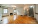 Spacious living room with hardwood floors, fireplace, and ample natural light from large windows at 2400 Commonwealth Ave, Charlotte, NC 28205