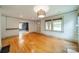Well-lit living room with hardwood floors, large windows, and views into an adjacent dining area at 2400 Commonwealth Ave, Charlotte, NC 28205