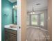 Stylish bathroom features a modern vessel sink, elegant mirror, and beautiful blue walls at 2439 Caswell Ct, Gastonia, NC 28054