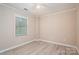 Bright bedroom features a ceiling fan, modern flooring, and a window for natural light at 2439 Caswell Ct, Gastonia, NC 28054