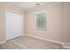 Neutral bedroom boasts a ceiling fan, modern flooring, a closet and a window for natural light at 2439 Caswell Ct, Gastonia, NC 28054