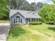 Inviting gray home with neat landscaping and traditional architectural details and trimmed shrubbery at 2439 Caswell Ct, Gastonia, NC 28054