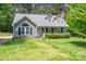 Charming gray home with a well-manicured lawn and inviting front porch and trimmed shrubbery at 2439 Caswell Ct, Gastonia, NC 28054
