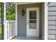 Close-up of the front door with a storm door, painted trim, and exterior light fixture at 2439 Caswell Ct, Gastonia, NC 28054