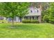 Attractive home featuring a manicured lawn, dark shutters, and a brick chimney at 2439 Caswell Ct, Gastonia, NC 28054