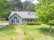 Charming home with dormer windows, dark shutters, and a well-maintained front lawn at 2439 Caswell Ct, Gastonia, NC 28054