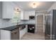 Stylish kitchen with stainless steel appliances, granite countertops, white cabinets, and modern backsplash at 2439 Caswell Ct, Gastonia, NC 28054