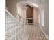 Bright living room with a brick fireplace, vaulted ceilings, light wood floors, and staircase at 2439 Caswell Ct, Gastonia, NC 28054