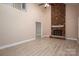 Vaulted ceilings with open-concept living room featuring a brick fireplace and light wood floors at 2439 Caswell Ct, Gastonia, NC 28054