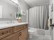 Modern bathroom with wood cabinets, stone countertop, and shower and tub combo at 246 Mcduffie Ln, Fort Mill, SC 29715