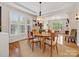Elegant dining room with large windows, stylish furniture, and a view into the living room at 246 Mcduffie Ln, Fort Mill, SC 29715