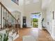 Bright foyer with hardwood floors, staircase, and front door view of the outside at 246 Mcduffie Ln, Fort Mill, SC 29715