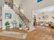 Spacious foyer featuring hardwood floors, staircase, and views into the adjacent living spaces at 246 Mcduffie Ln, Fort Mill, SC 29715