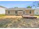 Backyard view of a single-story home with a small deck and well-maintained landscape at 2512 Captains Watch Ne Rd, Kannapolis, NC 28083
