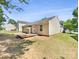 Spacious backyard featuring a small deck, lawn, and the home's tan siding at 2512 Captains Watch Ne Rd, Kannapolis, NC 28083