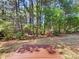 Private backyard with mature trees and a wooden platform, ideal for outdoor enjoyment at 2512 Captains Watch Ne Rd, Kannapolis, NC 28083