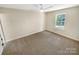 Spacious bedroom with neutral carpet, a ceiling fan, and a window bringing in natural light at 2512 Captains Watch Ne Rd, Kannapolis, NC 28083
