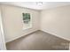 Comfortable bedroom with neutral walls and carpet, perfect for relaxation and rest at 2512 Captains Watch Ne Rd, Kannapolis, NC 28083