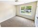 Bright bedroom with a neutral carpet and a large window overlooking the landscaped outdoors at 2512 Captains Watch Ne Rd, Kannapolis, NC 28083