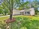 Charming single-story home featuring manicured lawn and mature shade tree in front yard at 2512 Captains Watch Ne Rd, Kannapolis, NC 28083