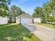 Attached two-car garage with a long driveway and well-maintained lawn at 2512 Captains Watch Ne Rd, Kannapolis, NC 28083