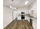 Modern kitchen with white cabinets, granite countertops, and stainless steel appliances on a hardwood floor at 2512 Captains Watch Ne Rd, Kannapolis, NC 28083