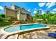 Expansive backyard features a pool, spa, outdoor kitchen, stone retaining walls, and lush landscaping at 288 Ridge Reserve Dr, Lake Wylie, SC 29710