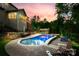 The backyard pool area is lit by sunset skies with the kitchen, hot tub and surrounding trees at 288 Ridge Reserve Dr, Lake Wylie, SC 29710