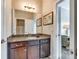 Bathroom with granite countertop vanity and decorative mirror; neutral tones and an open doorway at 288 Ridge Reserve Dr, Lake Wylie, SC 29710