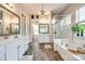 Bright Primary bathroom with double vanity, garden tub, glass shower, and wood floors at 288 Ridge Reserve Dr, Lake Wylie, SC 29710