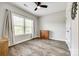Bright bedroom with a window, wooden cabinet, ceiling fan, and hardwood flooring at 288 Ridge Reserve Dr, Lake Wylie, SC 29710