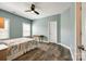 A bright bedroom with light-blue walls, a ceiling fan and hardwood floors at 288 Ridge Reserve Dr, Lake Wylie, SC 29710