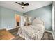Bedroom featuring pastel blue walls, hardwood floors, and ensuite bathroom at 288 Ridge Reserve Dr, Lake Wylie, SC 29710