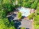 Scenic aerial view of a community pool surrounded by lush greenery and ample parking at 288 Ridge Reserve Dr, Lake Wylie, SC 29710