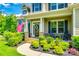 Inviting front porch with rocking chairs, American flag, and decorative wreath, perfect for relaxing at 288 Ridge Reserve Dr, Lake Wylie, SC 29710