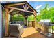 Outdoor living area with grill, comfortable seating, and a beautiful backyard view at 288 Ridge Reserve Dr, Lake Wylie, SC 29710