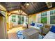 Covered outdoor living area with comfortable seating, grill, and a view of the backyard at 288 Ridge Reserve Dr, Lake Wylie, SC 29710