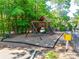 Community playground area featuring swings and a playhouse, nestled in trees at 288 Ridge Reserve Dr, Lake Wylie, SC 29710