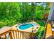 Aerial view of private backyard pool and patio with hot tub and lush landscaping surrounded by tall trees at 288 Ridge Reserve Dr, Lake Wylie, SC 29710