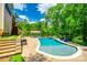 Spacious backyard with a sparkling pool, a covered kitchen area, a hot tub, and surrounding landscaping at 288 Ridge Reserve Dr, Lake Wylie, SC 29710