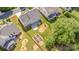Aerial view showcasing the backyard featuring a stone patio, garden, and well-kept landscaping at 3005 Sandbox Cir, Indian Trail, NC 28079