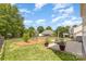 Backyard featuring large lawn, manicured garden, and mature trees at 3005 Sandbox Cir, Indian Trail, NC 28079